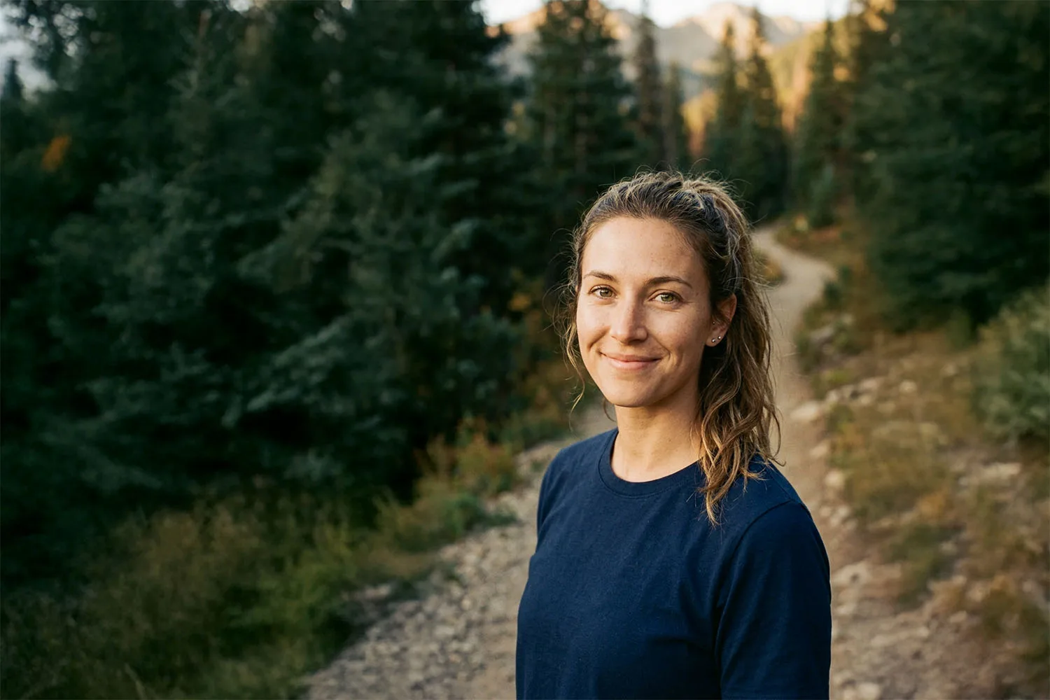 Jess Harmon outdoors with a handheld radio